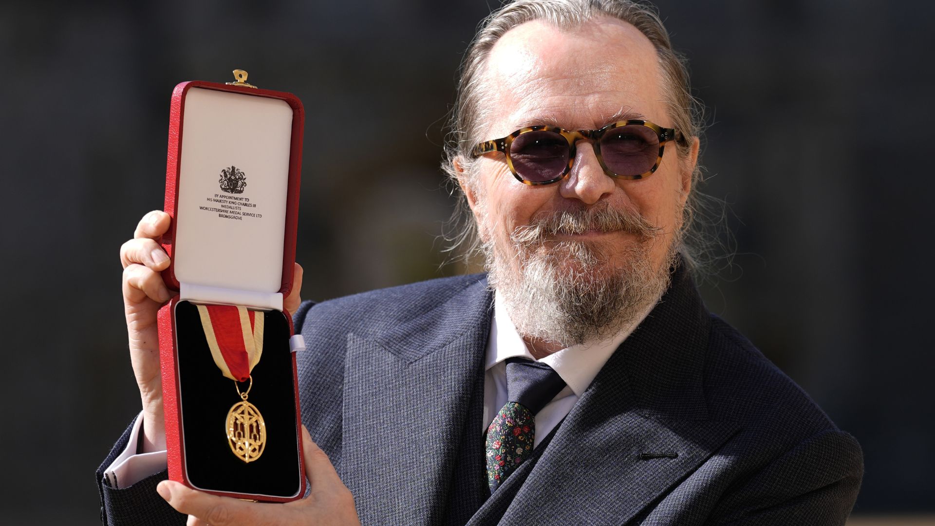 Sir Gary Oldman poses after being made a Knight Bachelor at an investiture ceremony at Windsor Castle
