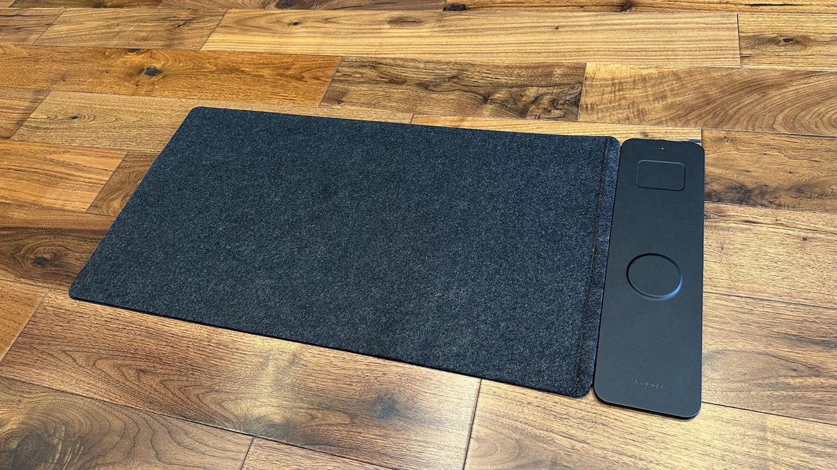The Journey ALTI Wireless charging desk mat in a wood-lined office