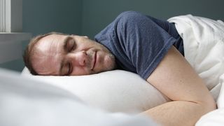 Man sleeping on his side with his mouth closed