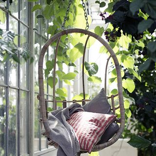 hanging chair with cushions and plants