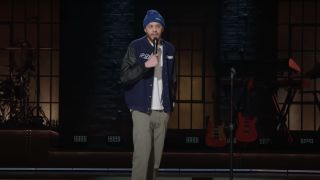 Peter Davidson performing stand-up comedy in a beanie in Netflix's Pete Davidson Presents The Best Friends