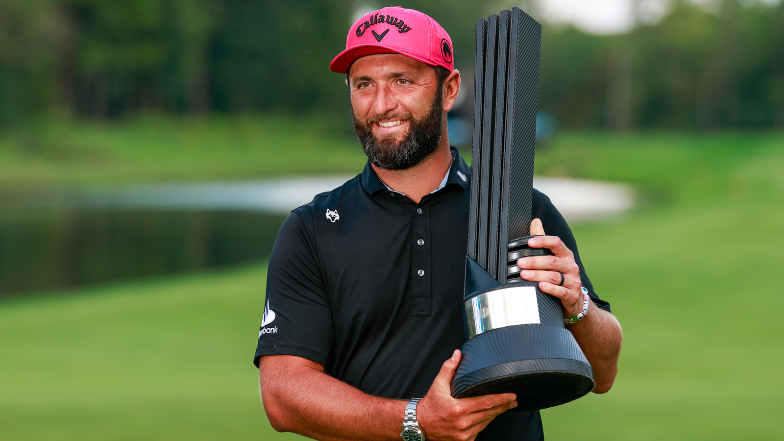 Jon Rahm holds a LIV Golf trophy