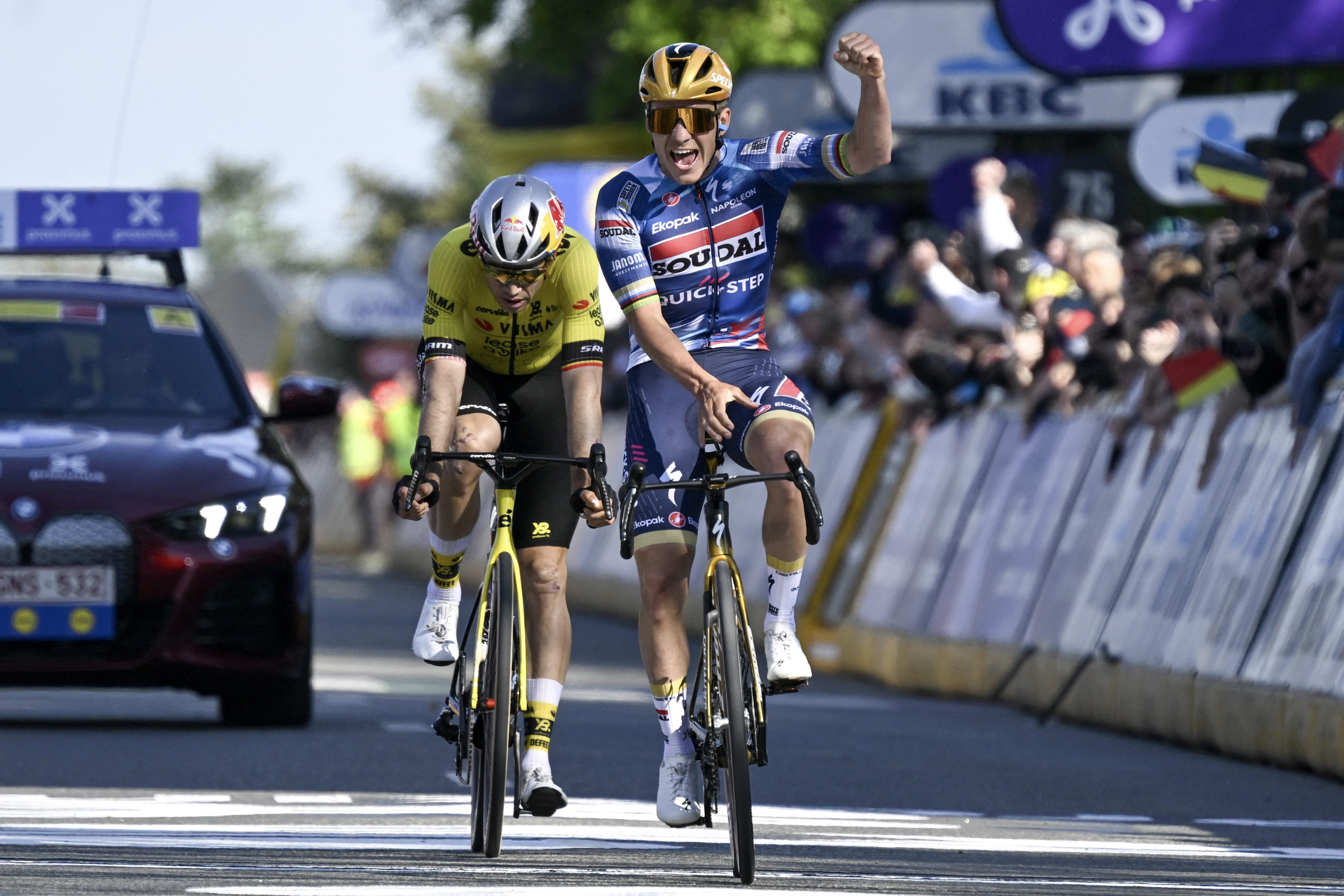 TOPSHOT - Belgian Remco Evenepoel of Soudal Quick-Step (R) celebrates ahead of Belgian Wout van Aert of Team Visma-Lease a Bike after crossing the finish line to win the men's 'Brabantse Pijl' one day cycling race, 162,5km from Huizingen, Beersel to Overijse on April 18, 2025. (Photo by Tom Goyvaerts / Belga / AFP) / Belgium OUT (Photo by TOM GOYVAERTS/Belga/AFP via Getty Images)