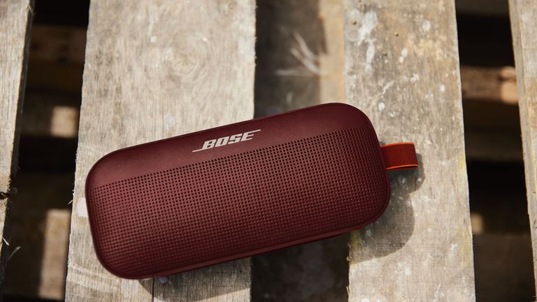 Best Bose Bluetooth speaker: Picytured here, the Bose Soundlink Flex in Carmine Red speaker on decking