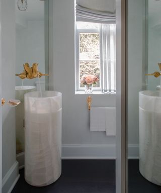 small bathroom with a mirror backsplash to maximize natural light