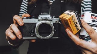 The Nikon FE film camera and three boxes of 35mm film