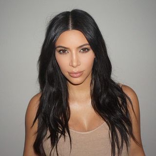 Kim Kardashian with centee parted hair.