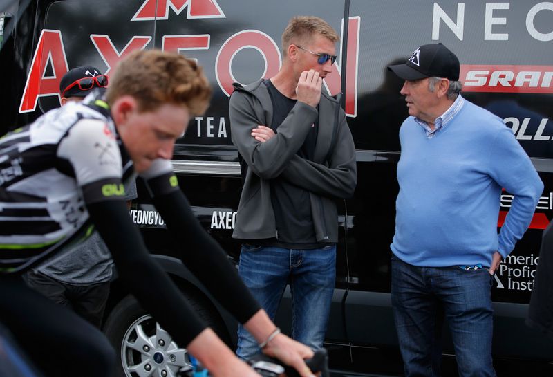 Axel Merckx chatting with his dad, Eddy Merckx before the start of stage 7 as Tao Geoghegan Hart warms up