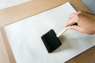 Paper is straightened out with a foam brush