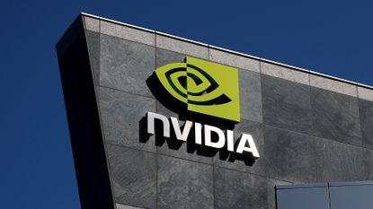 Nvidia logo and branding pictured on the side of the company's headquarters in Santa Clara, California, with clear blue skies pictured in background.