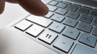 Close up of finger on keyboard button