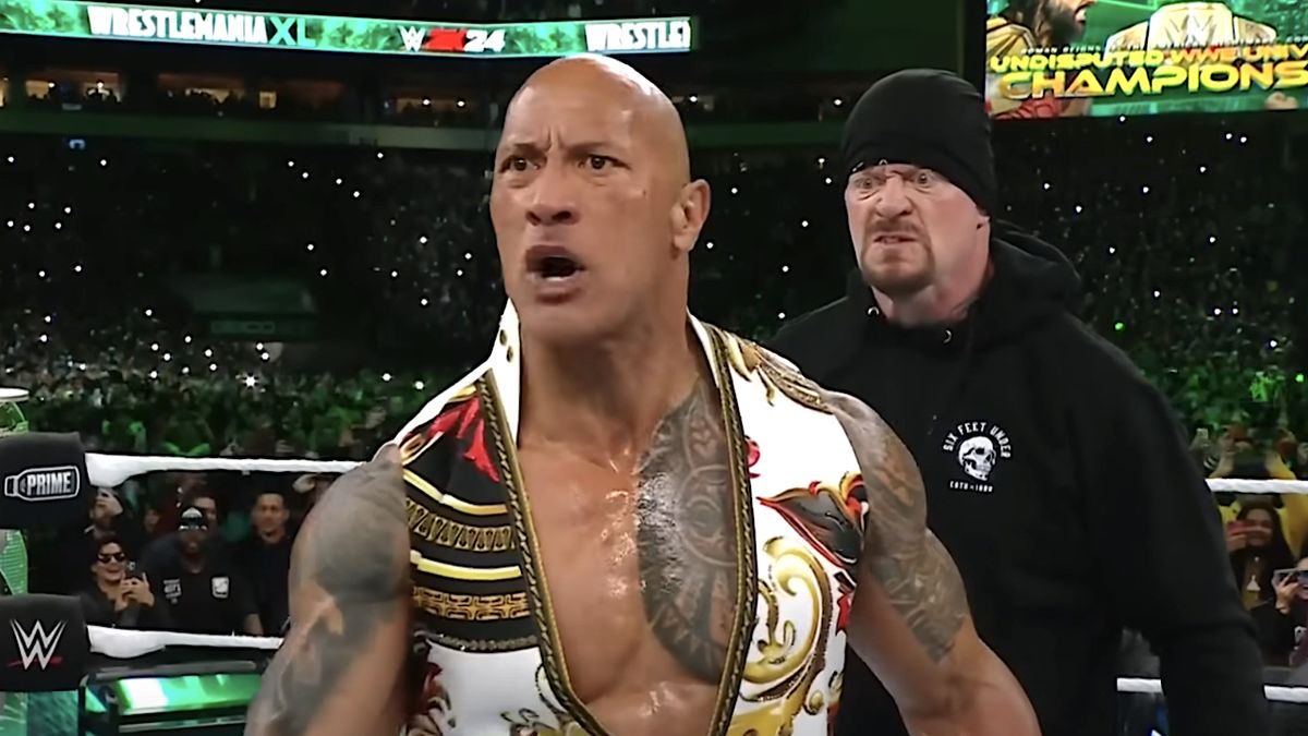 The Undertaker standing behind The Rock in the ring during WWE WrestleMania 40