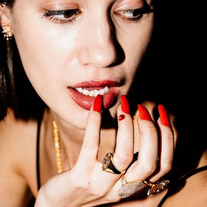 a woman wearing claws by tiger taylor biodegradable press-ons