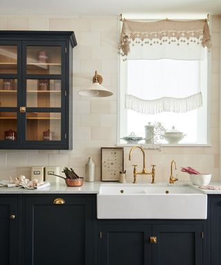 A black and white kitchen with classic wall lights