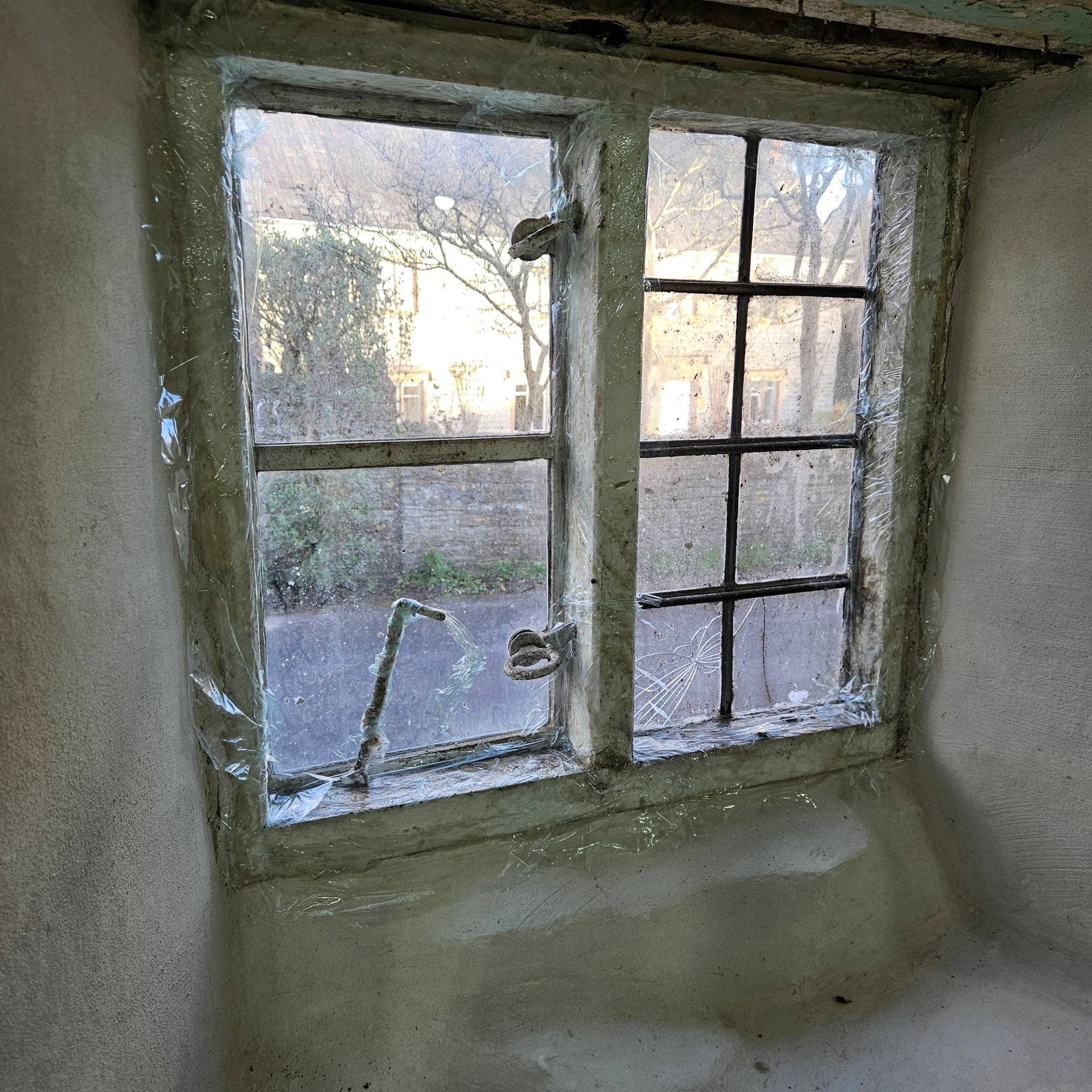 white windows with paint stripper and cling film