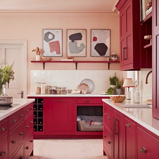 Deep pink kitchen cabinets against pale pink walls
