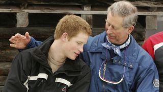Prince Charles poses with his son Prince Harry during the Royal Family's ski break at Klosters on March 31, 2005 in Switzerland.