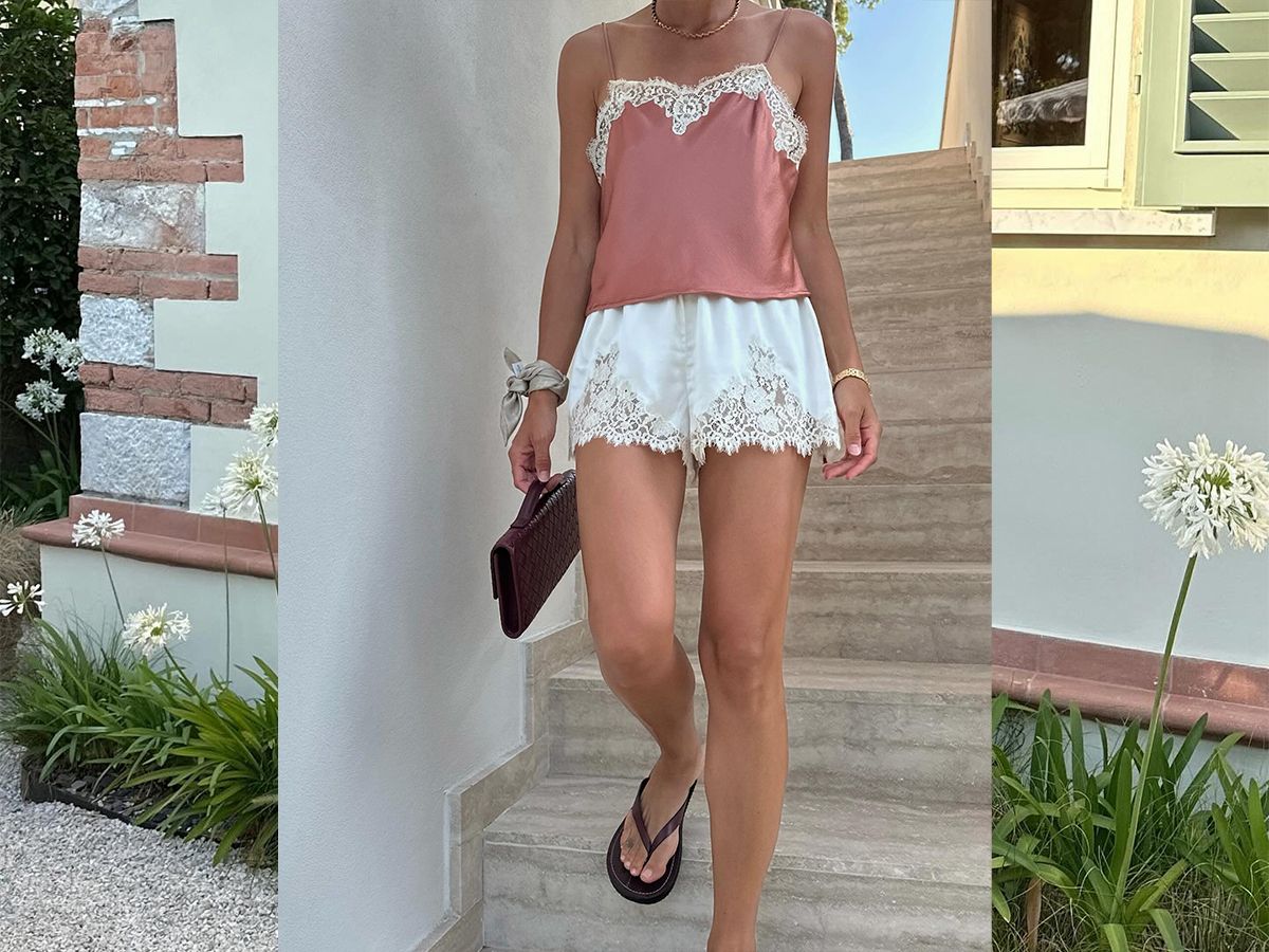 Influencer Jamie Ridge wears white lace trim shorts and a pink lace trim cami with brown flip flops.