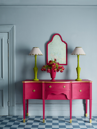 Checkerboard floor with pink console table
