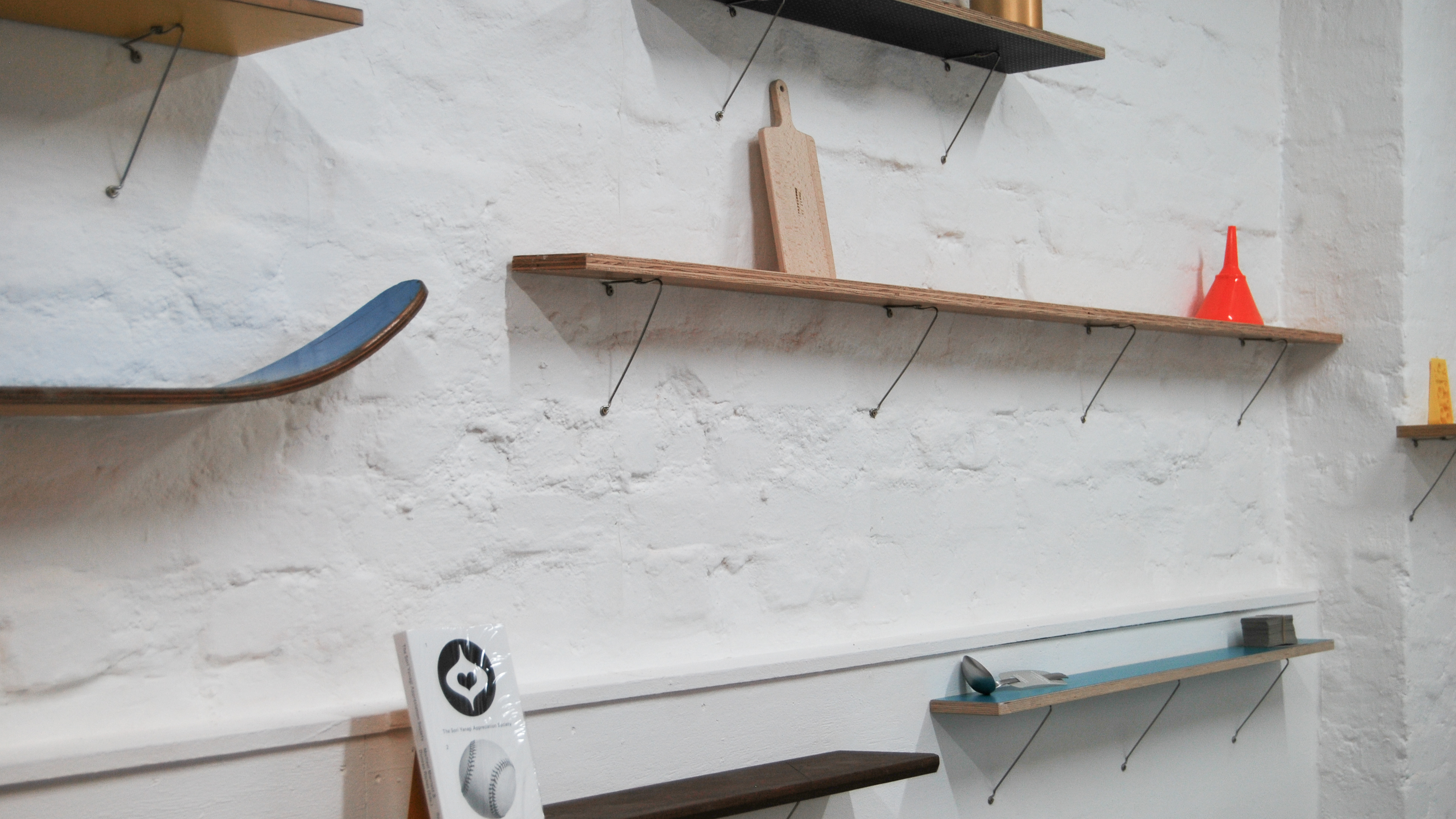 Shelving on a white brick wall