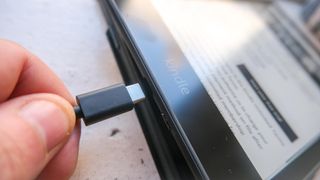 The Kindle Paperwhite 2021 with USB-C cable plugging in