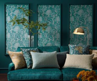 green living room with wallpapered wall panelling and jewel green velvet sofa