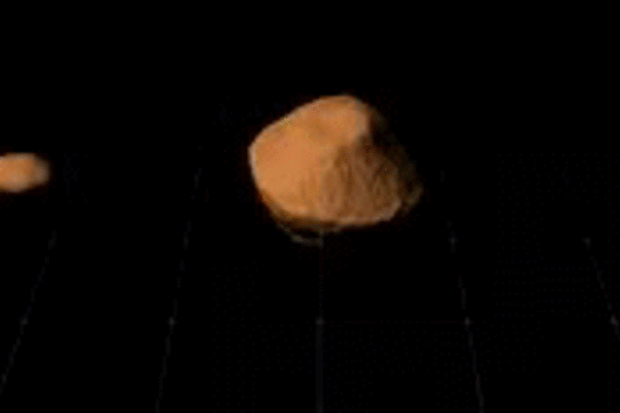 An animation shows what the orbit of a moon around asteroid 1999 KW4 looks like.