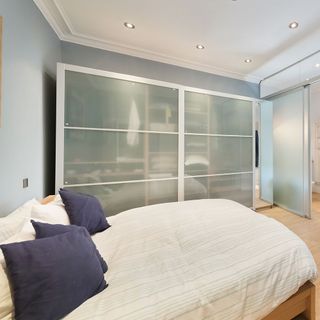 bedroom with wardrobe and wooden flooring