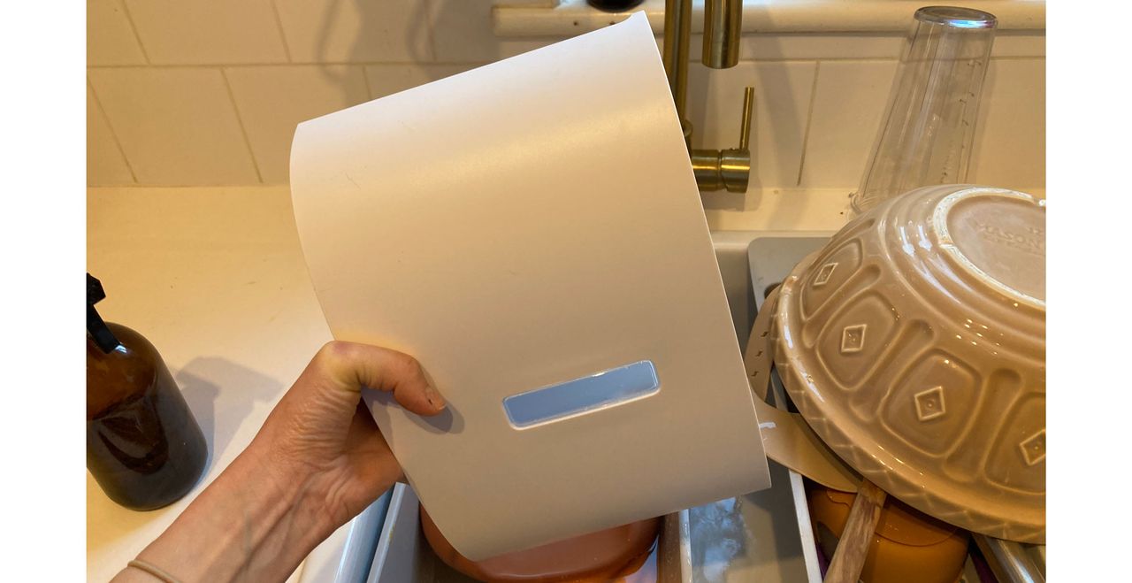 Tester emptying the water tank of the MeacoDry One dehumidifier review