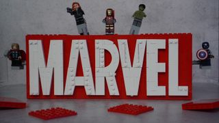 Lego Marvel Logo and Minifigures with minifigures popping out