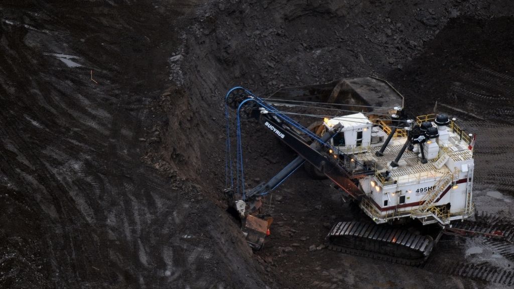 A large excavator loads a truck with oil sands at the Shell Albian mine near the town of Fort McMurray in Alberta Province, Canada on October 23, 2009.