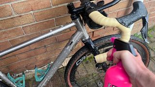 Muc-Off spray being used on gravel bike