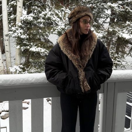 Bettina Looney wearing a black fur-trimmed jacket in the snow.