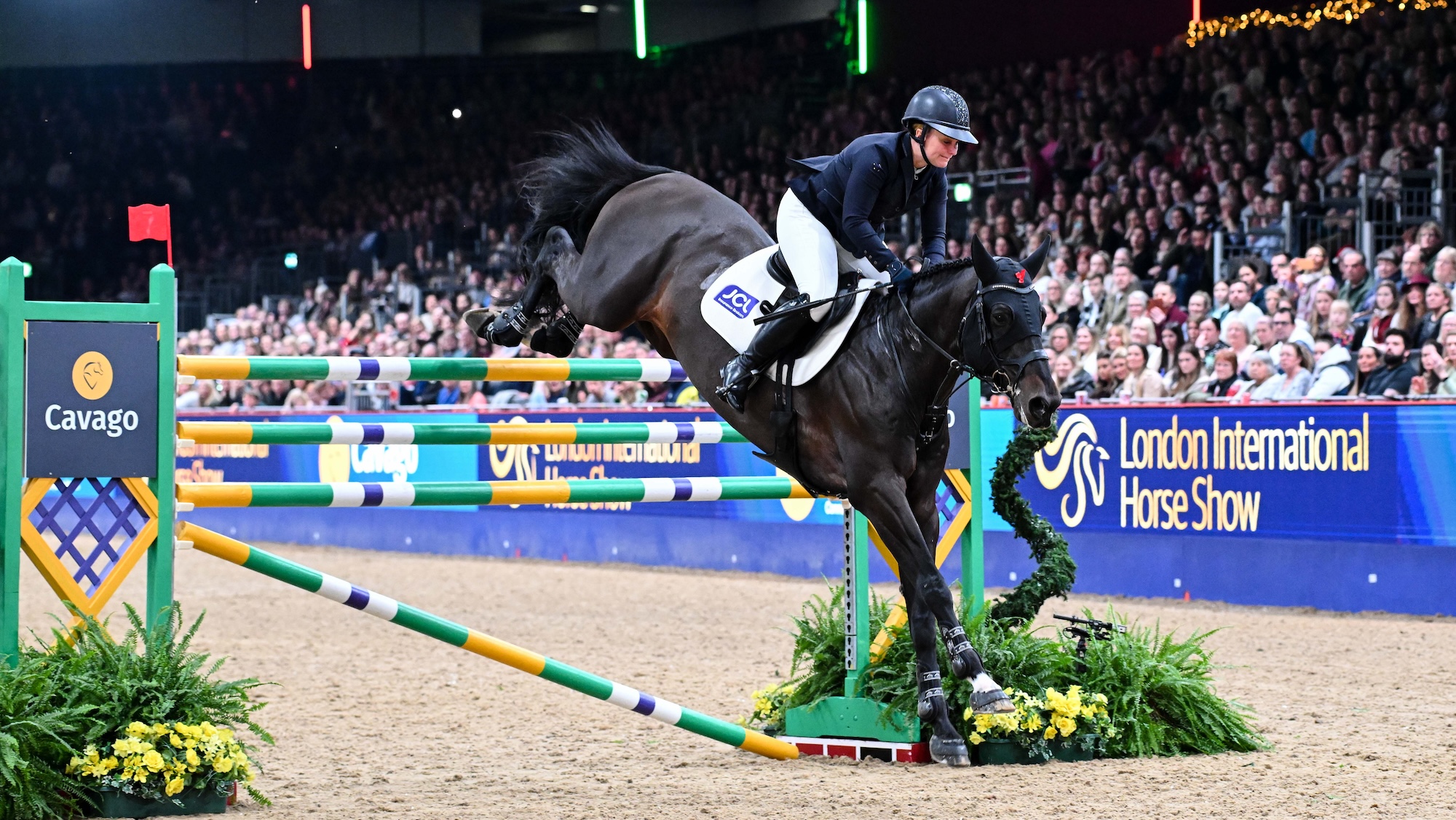 Gemma Stevens clearing a fence at the London International with Envoy Merelsnest Z