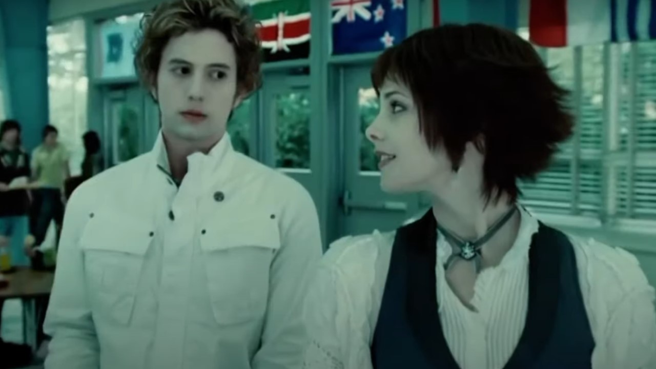 Alice (Ashley Greene) looks back at Jasper (Jackson Rathbone) as they walk through the school cafeteria in Twlight.