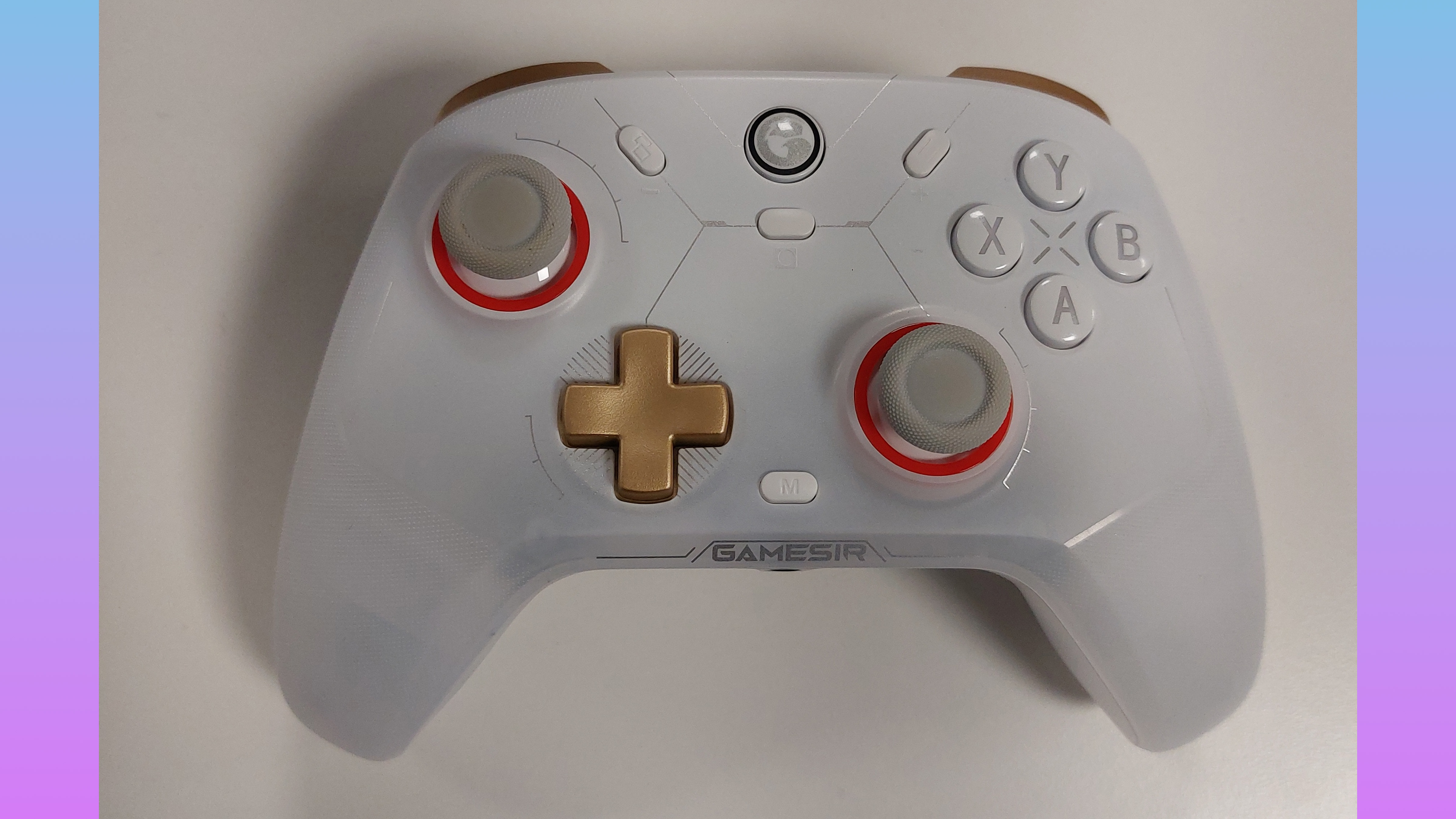 The GameSir Cyclone 2 controller in Phantom White. This colourway features a white gamepad body, a golden D-pad, golden shoulder buttons, grey thumbstick covers with orange thumbstick inlays, and silver text accents. The RGB lights are switched off in this image.