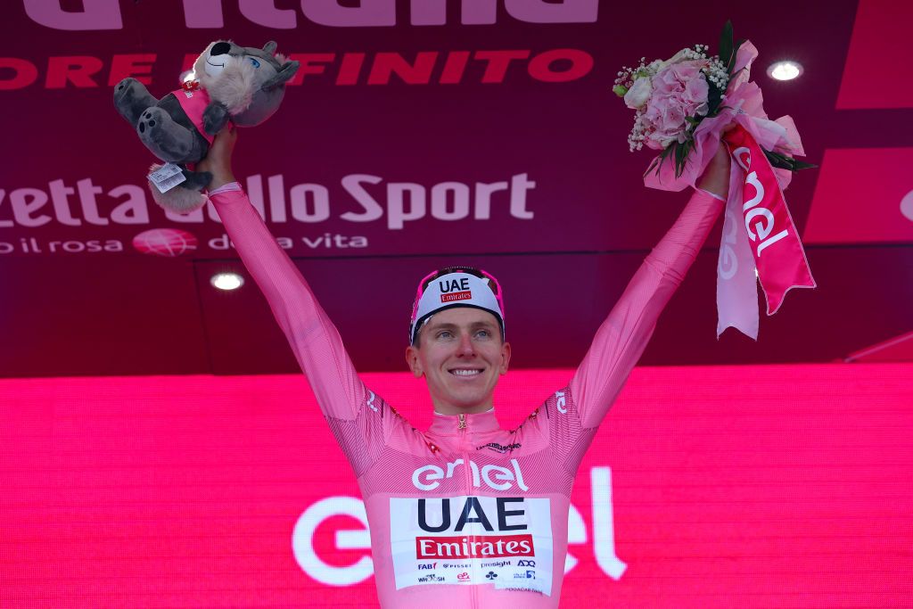 Team UAE's Slovenian rider Tadej Pogacar celebrates the overall leader's pink jersey on the podium of the 12th stage of the 107th Giro d'Italia cycling race, 193km between Martinsicuro and Fano, on May 16, 2024. (Photo by Luca Bettini / AFP)