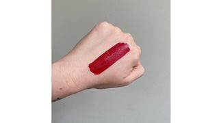 Swatch of Fenty Beauty Stunna Lip Paint in Uncensored red lipstick