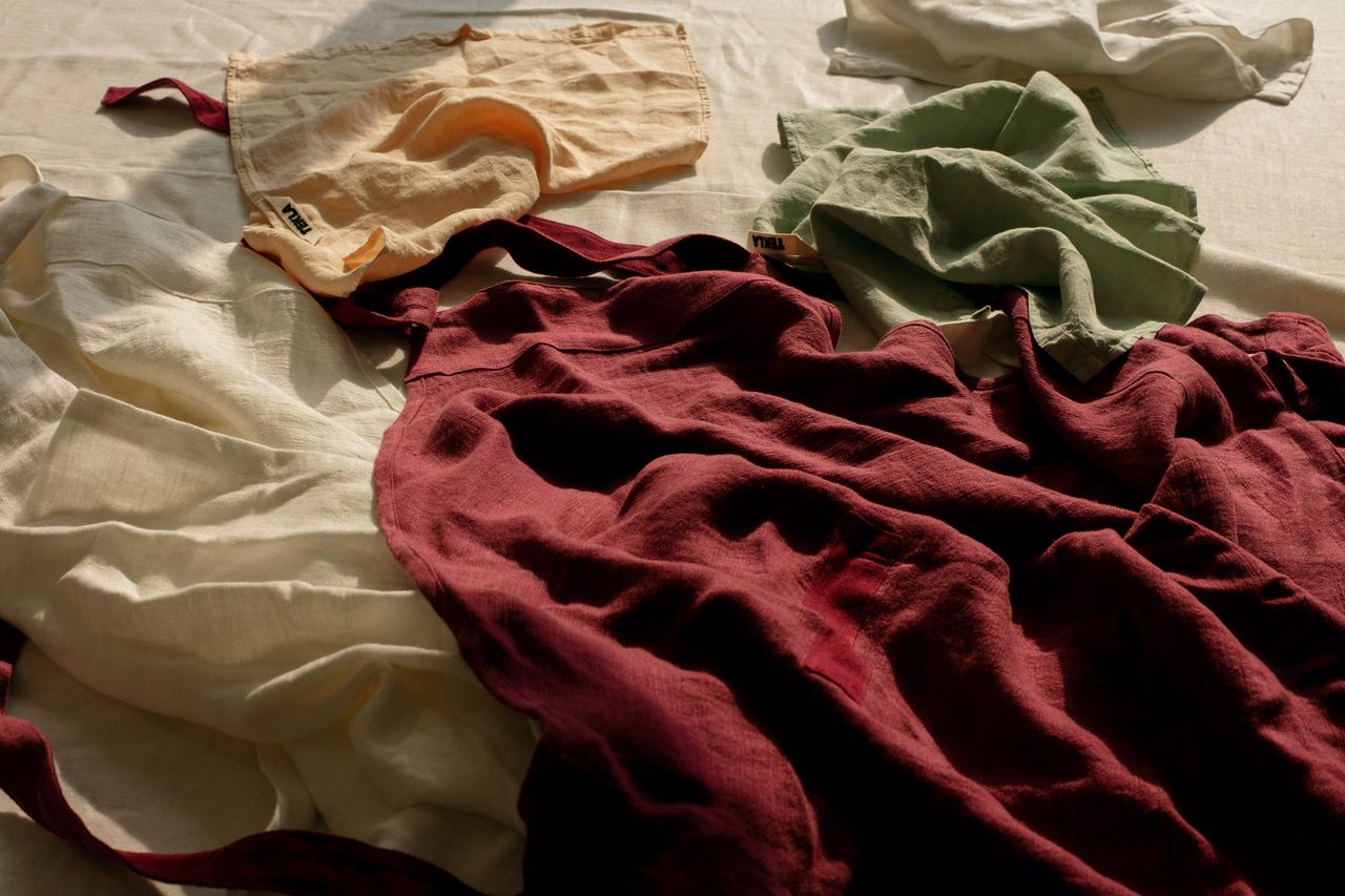 Textiles from the new kitchen line from Danish brand Tekla, including napkins and aprons in six rich hues.