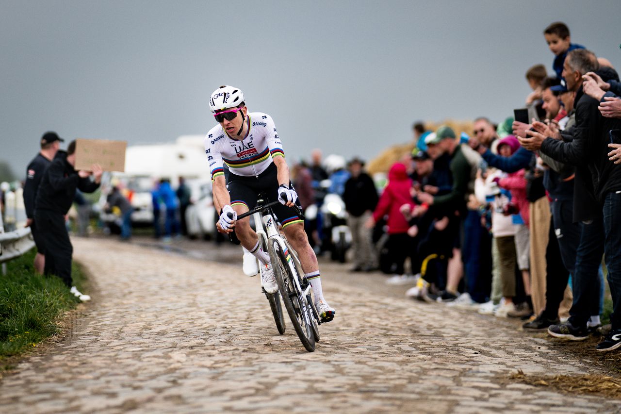Tadej Pogačar on the cobbled of Paris-Roubaix, in his world champion&#039;s jersey with black shorts