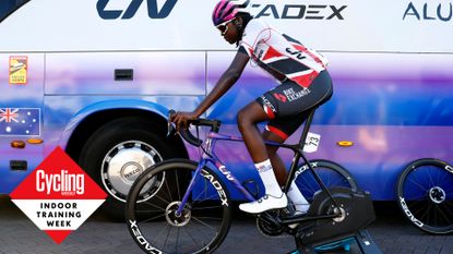 Image shows a professional cyclist training on a turbo trainer.