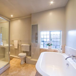 bathroom with white wall and bathtub