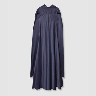 A cutout image of a navy sleeveless dress with a cape from Reiss against a grey background