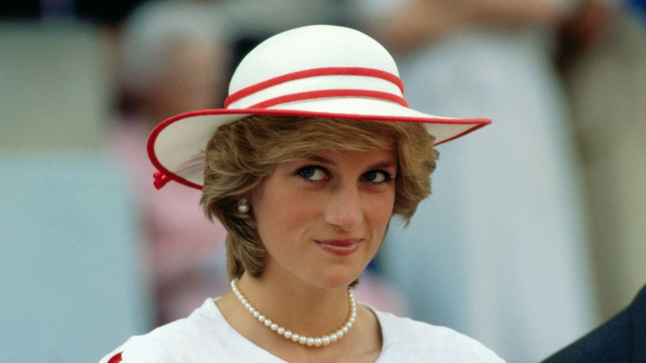 Diana, Princess of Wales, wears an outfit in the colors of Canada during a state visit to Edmonton, Alberta, with her husband.