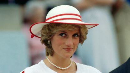 Diana, Princess of Wales, wears an outfit in the colors of Canada during a state visit to Edmonton, Alberta, with her husband.