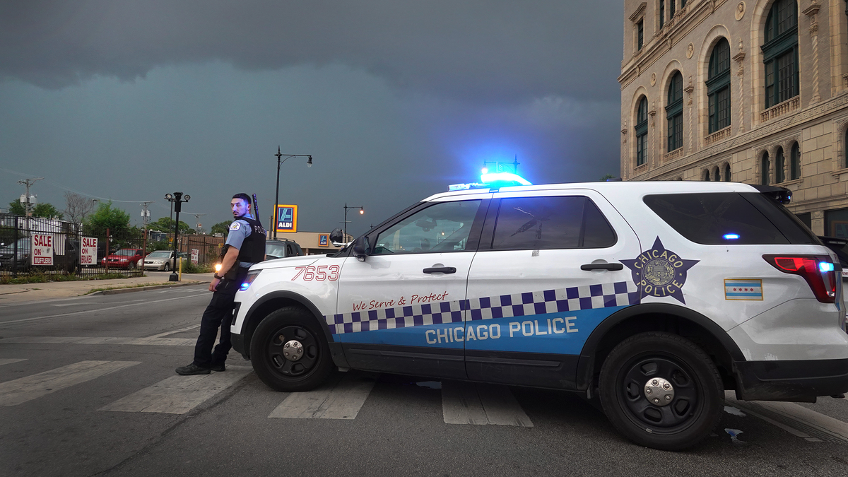 A police officer stands guard following unrest on the city&#039;s westside moments before a derecho storm hits the area on August 10, 2020 in Chicago, Illinois. The storm, with winds gusts close to 100 miles per hour, downed trees and power lines as it moved through the city and suburbs.