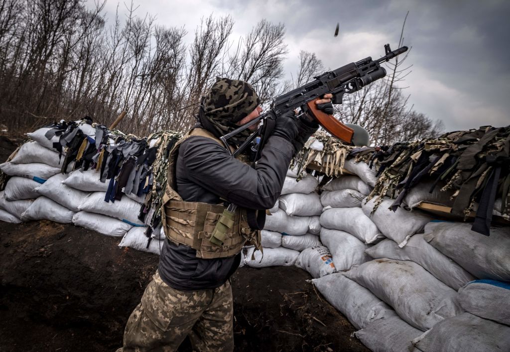 Ukrainian soldier pointing rifle at drone