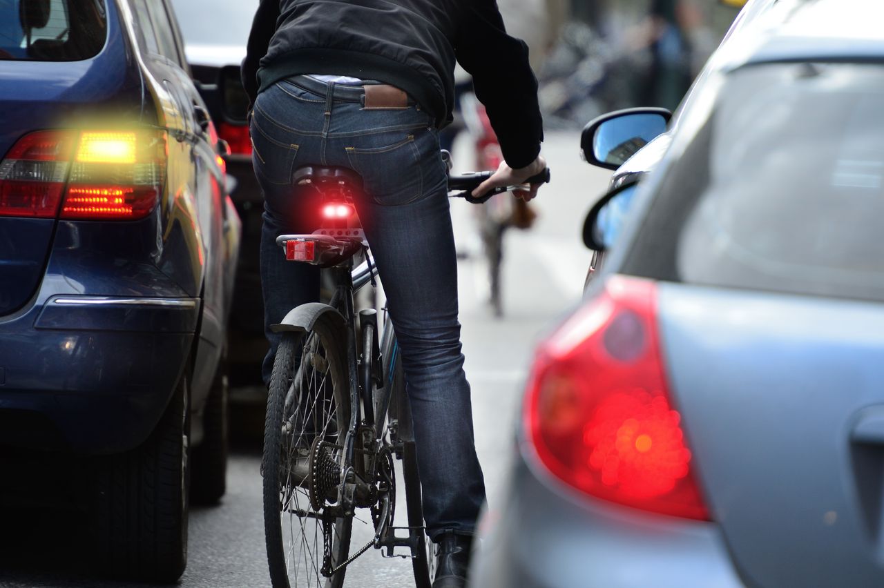 A cyclist drives through traffic