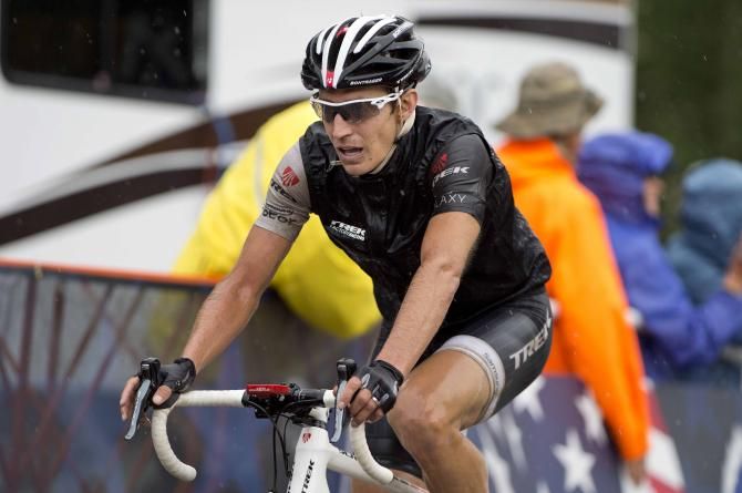 A very wet Matthew Busche (Trek) crosses the line