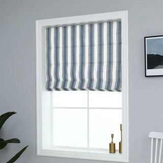 A blue and white striped Roman shade from Wayfair